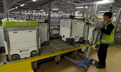 A technician prepares a ‘bot’ to be returned to the ‘smart platform’ at the Ocado customer fulfilment centre in Andover.