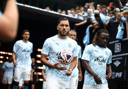Rayan Cherki (left) carries the ball as he and Jérémy Doku walk on to the pitch at the Club World Cup