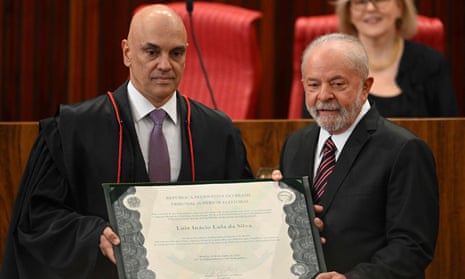 Luiz Inacio Lula da Silva (R) receives the “diploma” of President-elect of Brazil from Supreme Court Justice Alexandre de Moraes (L), on January 1, 2023.
