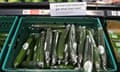 Cucumbers in fresh produce aisle at Asda