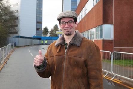 he is about 40 with short dark hair and beard, and wears glasses, a tweed peaked cap and a brown suede jacket with furry collar.