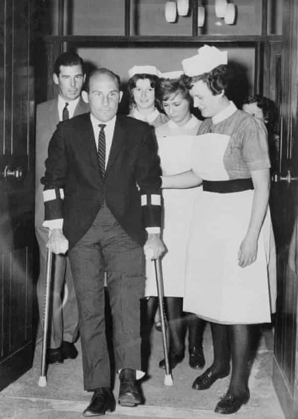 Stirling Moss leaving hospital in Wimbledon, south-west London, after the crash at Goodwood in April 1962 that brought an end to his racing career.