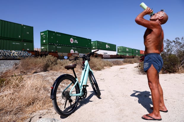 Daryl Luppino takes a drink during his bike ride near Palm Springs, California, on 9 July.