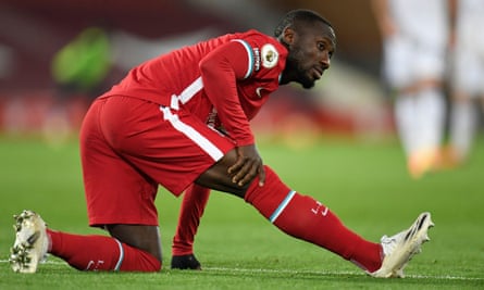 Liverpool's Naby Keïta holds his hamstring after being injured