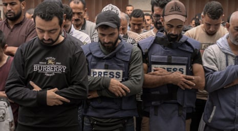 Yasser Qudih performs funeral prayer after losing eight of his relatives during Israeli attacks