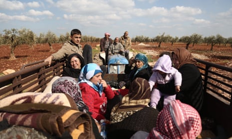 Kurdish civilians flee Afrin in northern Syria after Turkey said its army and allied rebel groups had surrounded the city, March 2018