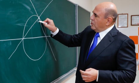 Russia’s Prime Minister Mikhail Mishustin draws on a chalkboard while visiting the Kapitsa Physics and Technology Lyceum in the town of Dolgoprudny earlier this month.
