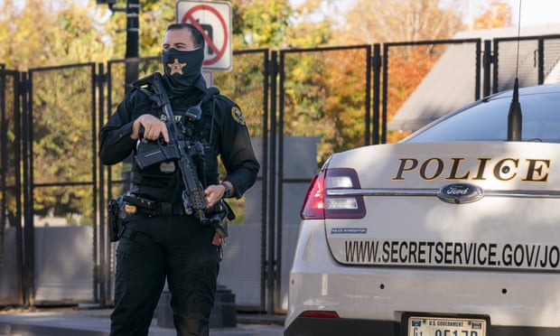 A secret service agent guards a building