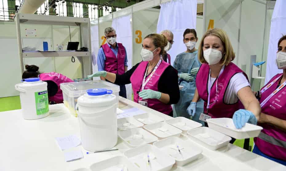 Health workers prepare syringes with the AstraZeneca vaccine at the vaccination centre inside the former Tempelhof airport in Berlin.
