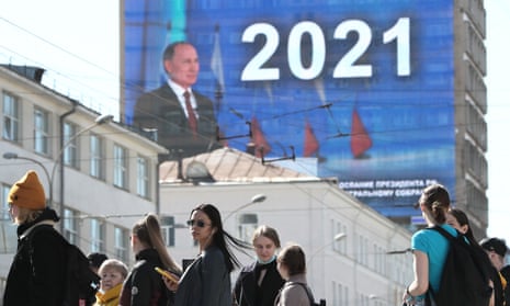 A live broadcast of Russian President Vladimir Putin’s annual address to the Federal Assembly of the Russian Federation on the facade of a building in Malysheva Street.