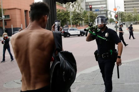 Man points cell phone at cop