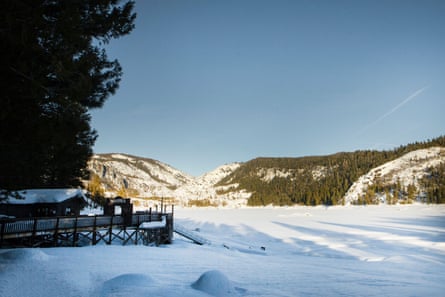 The marina at Pinecrest Lake is covered with snow, with the lake also covered in it.