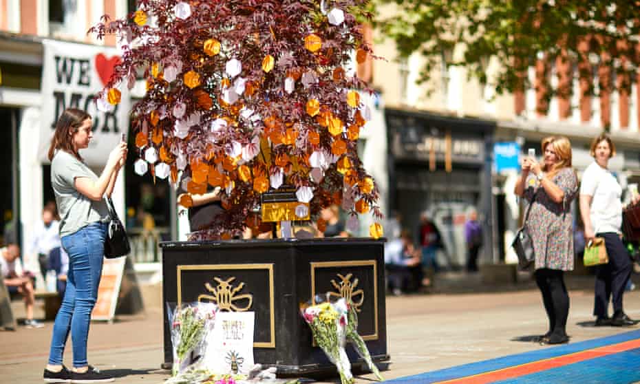 Visitors adding messages of tribute, solidarity and love on one of 28 Japanese maples forming the Trees of Hope trail from Victoria station to St Ann’s Square in Manchester