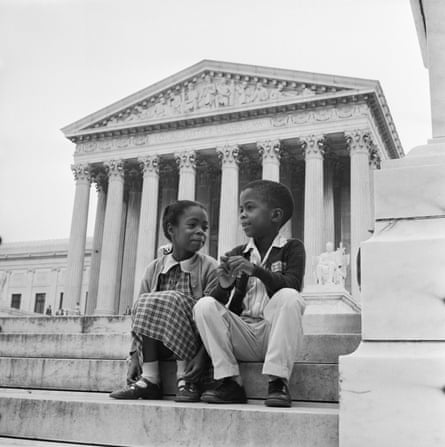 Two children sitting in front of the supreme court building