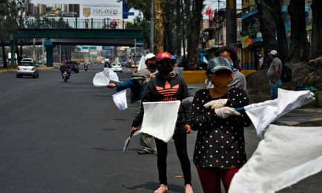 People wave white flags as a signal they need food, along a highway in Guatemala City.