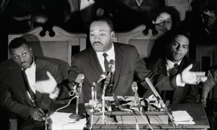 Dr. Martin Luther King Jr. speaking at Selma in February 1965, after his release from prison, with the support of his aides including Reverend Fred Shuttlesworth, left.