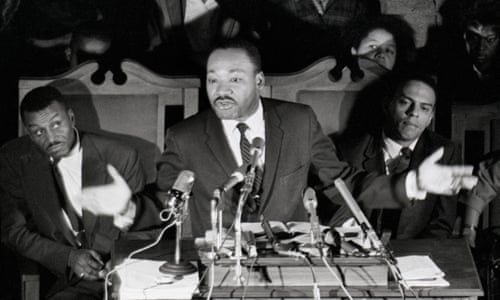 Dr Martin Luther King Jr speaks in Selma in February 1965, after his release from jail, supported by his aides including Rev Fred Shuttlesworth, left.