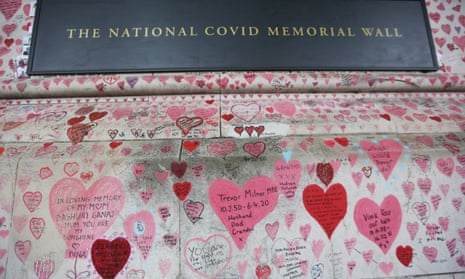 The National Covid Memorial Wall, drawn with red hearts and messages, in London. The wall stands south of the River Thames facing the Houses of Parliament.