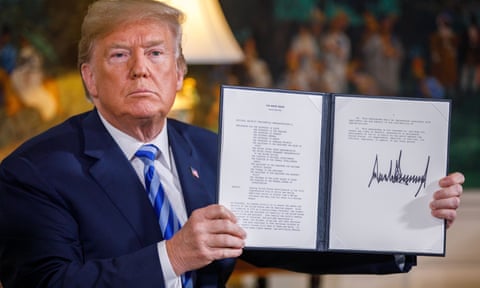 Donald Trump displays the signed presidential memorandum for new sanctions against Iran.