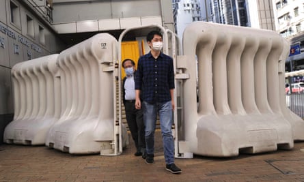 Pro-democracy legislator Ted Hui, right, leaves a police station in Hong Kong. Hui has protested over HSBC’s freezing of his bank account.