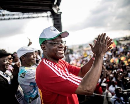 Maurice Kamto applauds as he arrives on stage at an election rally in September 2018