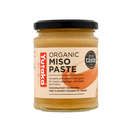 A glass jar of Yutaka Organic Miso Paste with a black lid on a white background