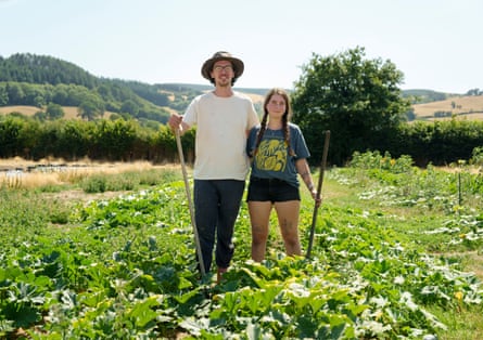 Lydia Dibben and Charlie James pose for a photo standing in their plot of land