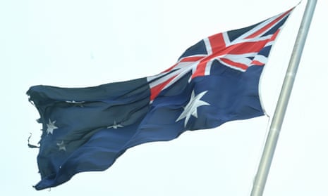 A torn Australian flag is seen on top of Parliament House in Canberra