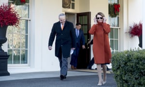 Nancy Pelosi and Chuck Schumer walk out of the West Wing after their meeting with Donald Trump on 11 December.