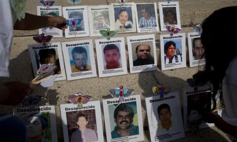 Women adorn photographs of missing people to call attention to the cases on Mothers Day in Mexico City, on 10 May.