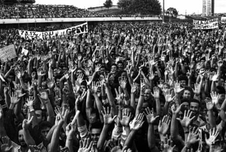 Stadium full of people raising their hands