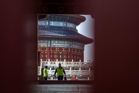 Workers are seen through a gap in doors