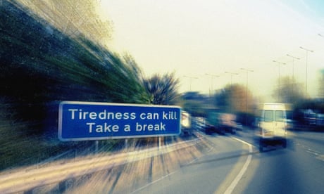 Road and sign saying 'Tiredness can kill Take a break'