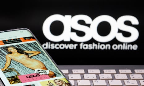A smartphone with an Asos app in front of a keyboard and an Asos logo