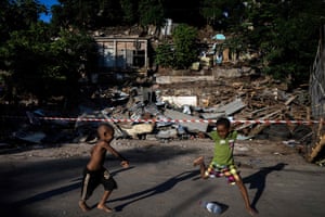 Children play football in slum