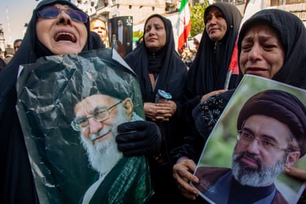 People hold portraits of the late supreme leader, Ali Khamenei and his son, Iran’s new supreme leader, Mojtaba Khamenei