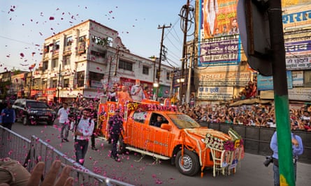 Narendra Modi, center in a saffron cap, and the chief minister of Uttar Pradesh, Yogi Adityanath, campaign in Ghaziabad