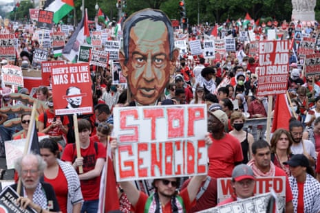 Protesters hold signs that say ‘stop genocide’ and a placard of Benjamin Netanyahu’s face