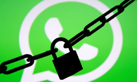 A padlocked chain in front of a displayed WhatsApp logo