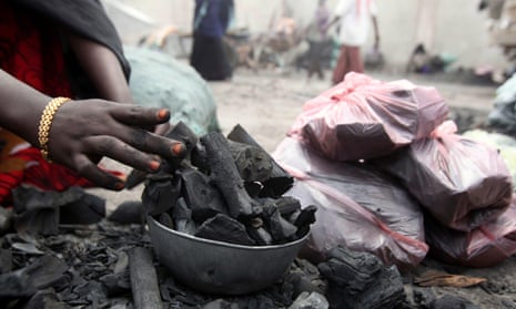 A Somali businesswoman arranges charcoal at her stall along a street near the main Baraka market in Mogadishu.