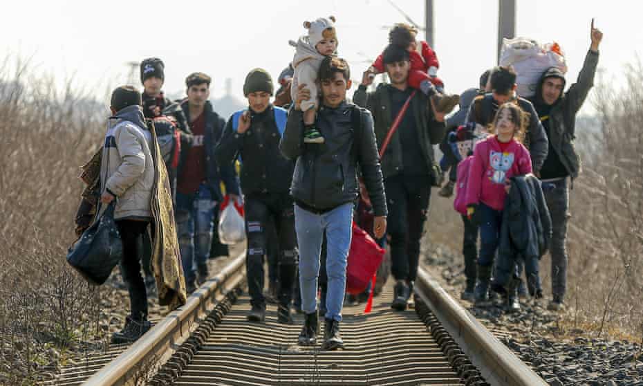 Migrants walking toward Greece along a railway track near the Pazarakule border crossing in Edirne, Turkey, on Sunday.