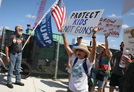 A Trump supporter looks on at people gathered outside the Mar-a-Lago club for a March for Our Lives in Florida in 2018.