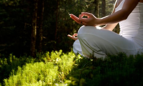 Woman sitting in meditating position outdoors