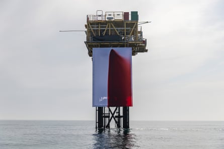 Gas rig with huge red-stained canvas hanging off it