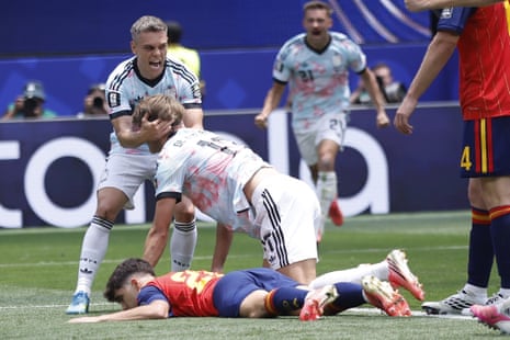 Charles De Ketelaere (kneeling) is congratulated by teammate Leandro Trossard (left) after scoring Belgium’s equalizer against Spain.