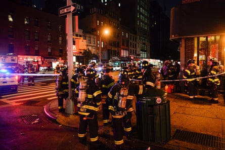 New York City firefighters stand near the site of the blast.
