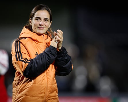 The Arsenal head coach, Renée Slegers, applauds fans after the game.