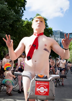 A participant wears a Donald Trump mask as he cycles near Lincoln's Inn Fields