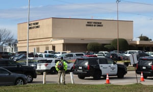 A person stands near the scene of a church shooting at West Freeway Church of Christ on Sunday in White Settlement, Texas.