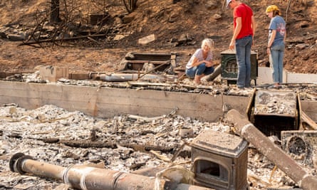 Resident Wendy Weight, left, reacts while viewing the burned remains of her home in Greenville, California, on 4 September.